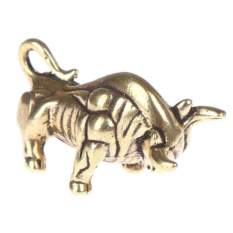 Gold bull charm on a white background