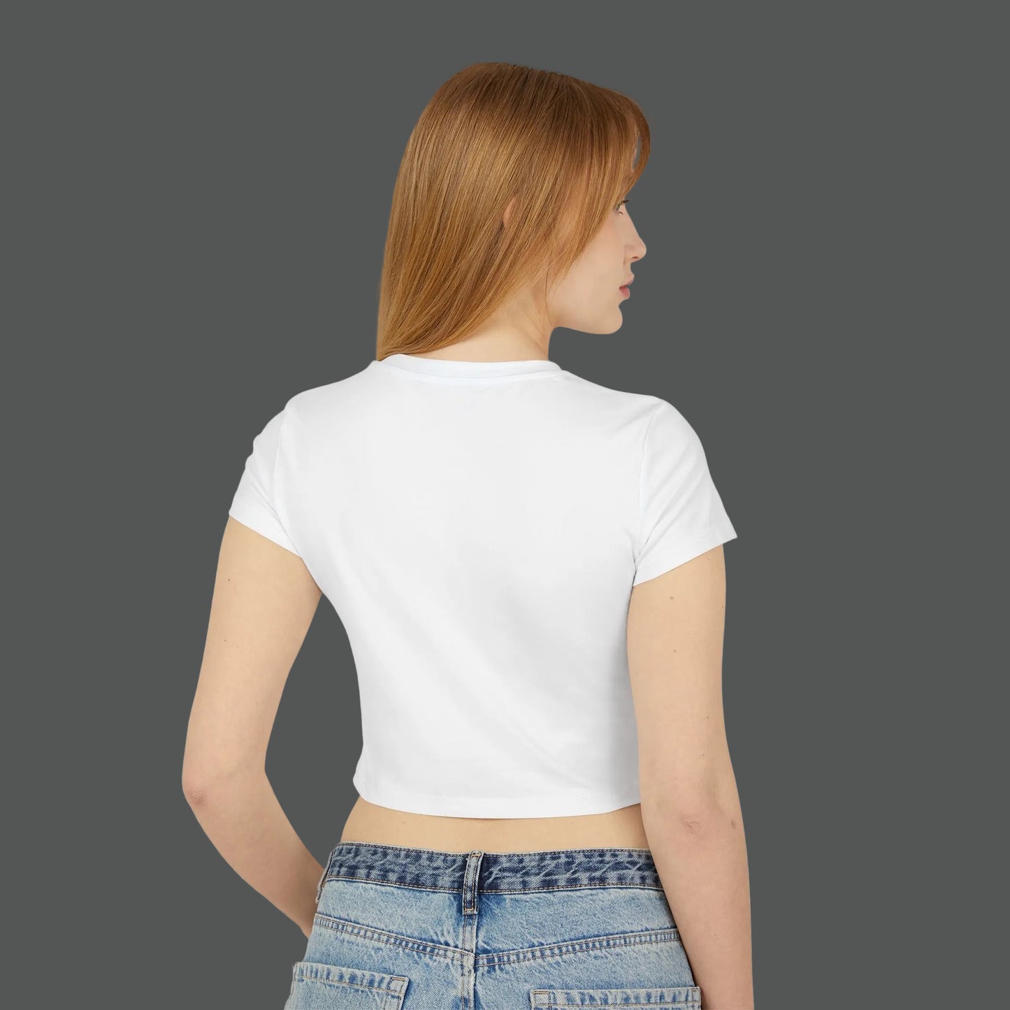 Woman wearing a white crop top and blue jeans on a white background