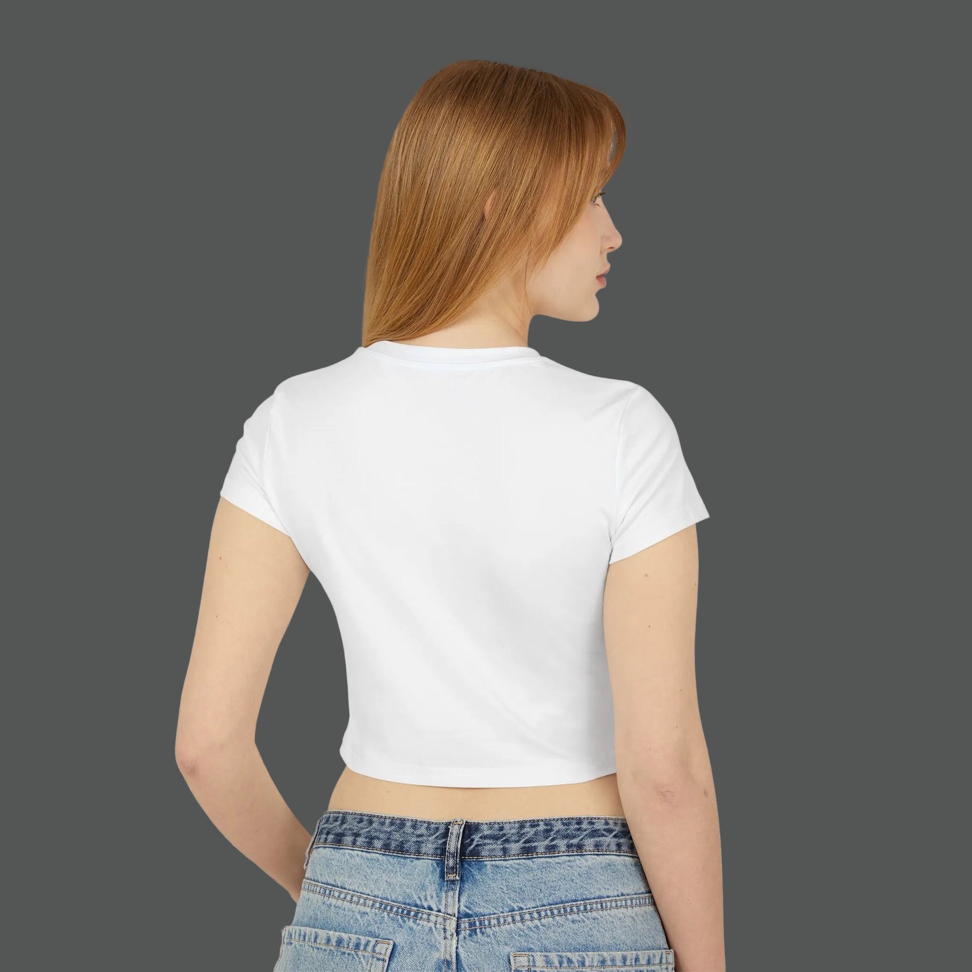 Woman wearing a white crop top and blue jeans on a white background