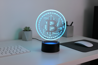Desk with a Bitcoin-themed lamp, keyboard, and mouse.