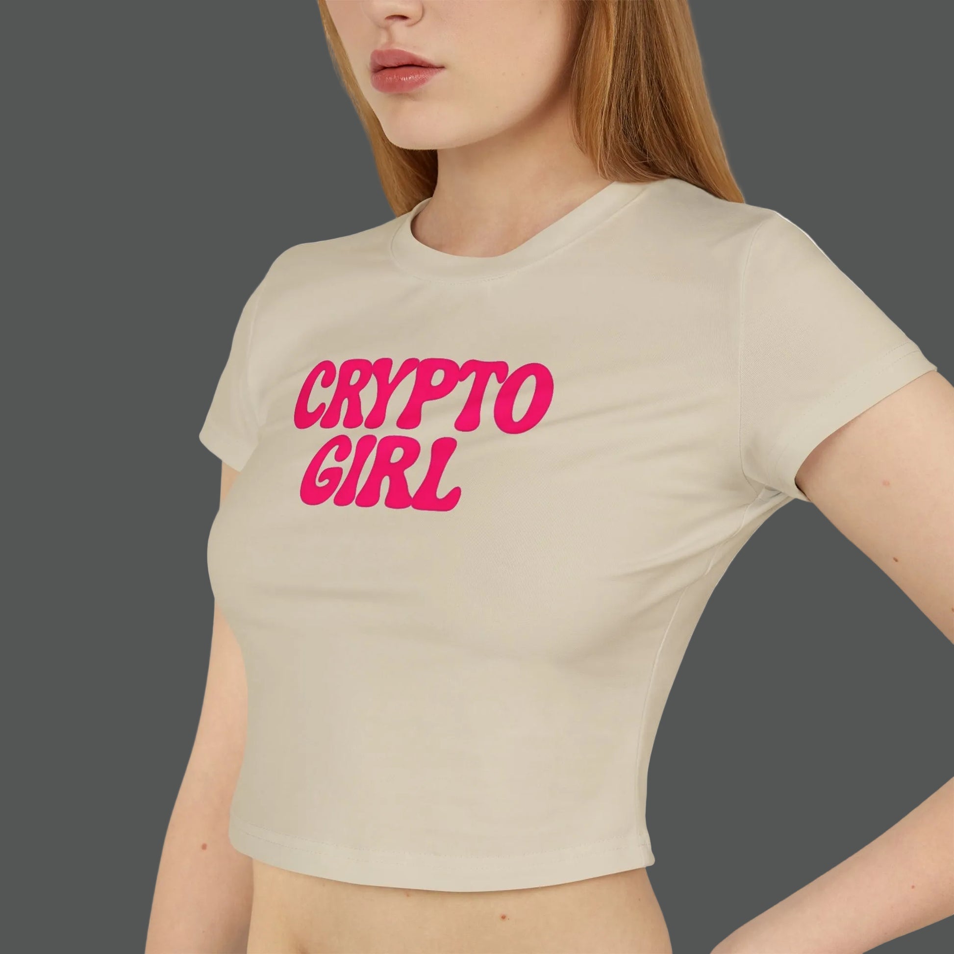 Beige t-shirt with 'CRYPTO GIRL' in pink text worn by a person on a white background
