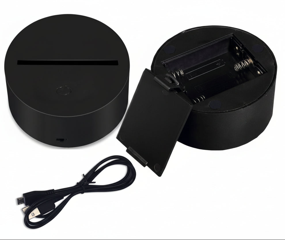Black electronic device with charging cable on a white background