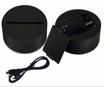 Black electronic device with charging cable on a white background
