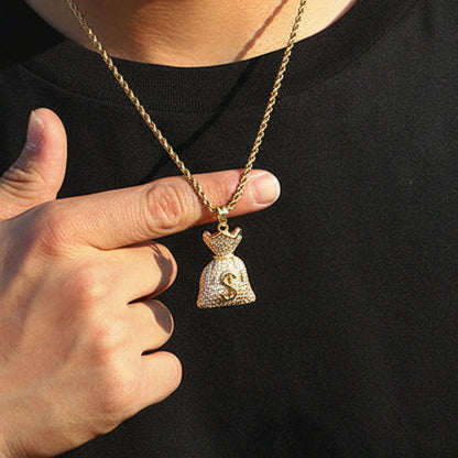 Person wearing a black t-shirt with 'ICE OUTBOX' logo, pointing to a gold necklace with a pendant.
