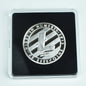 Silver litecoin coin in a clear case on a light gray background