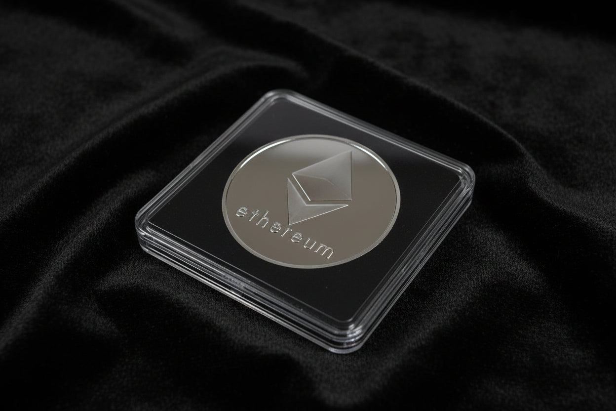 Ethereum coin in a clear case on a dark fabric background
