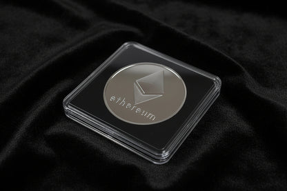 Ethereum coin in a clear case on a dark fabric background