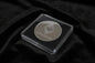 Ethereum coin in a clear case on a dark fabric background