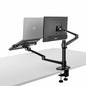 Black adjustable desk mount with laptop and monitor on a white background