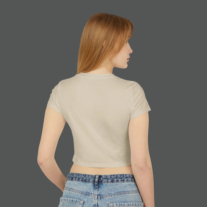 Woman wearing a beige crop top and blue jeans on a white background