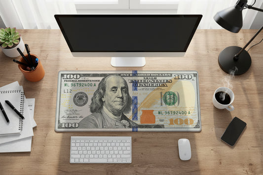 Desk setup with a computer monitor, keyboard, mouse, and a $100 bill as a placemat.