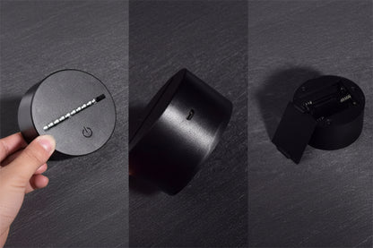 Close-up of a black cylindrical object with a hand holding it, on a dark gray background.