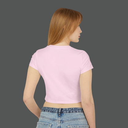 Woman wearing a pink crop top and blue jeans on a white background