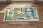 Large banknote design rug on a wooden floor