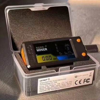 Digital device labeled 'NERD Z MINER' in a clear case on a textured surface.