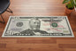 Fifty-dollar bill design rug on a wooden floor