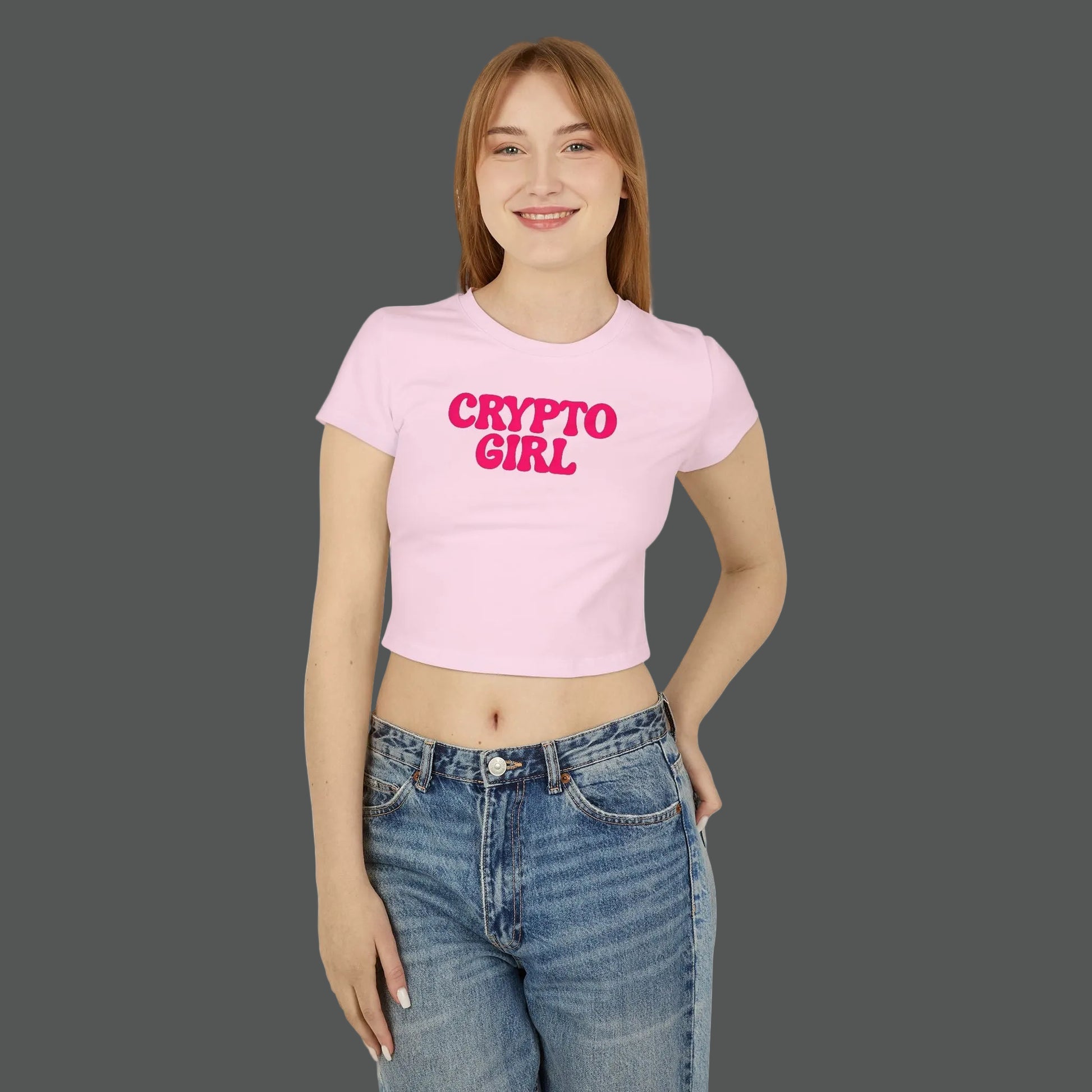 Person wearing a pink 'CRYPTO GIRL' t-shirt and blue jeans on a white background