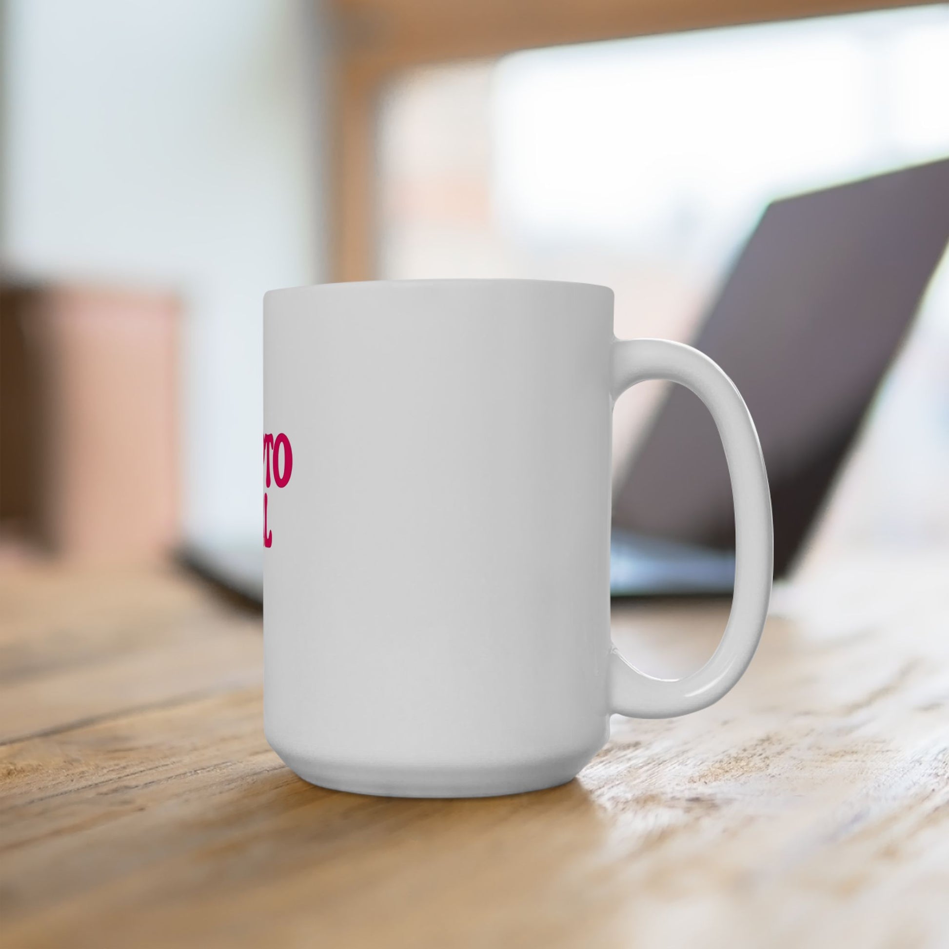 White mug with a cat illustration on a wooden surface