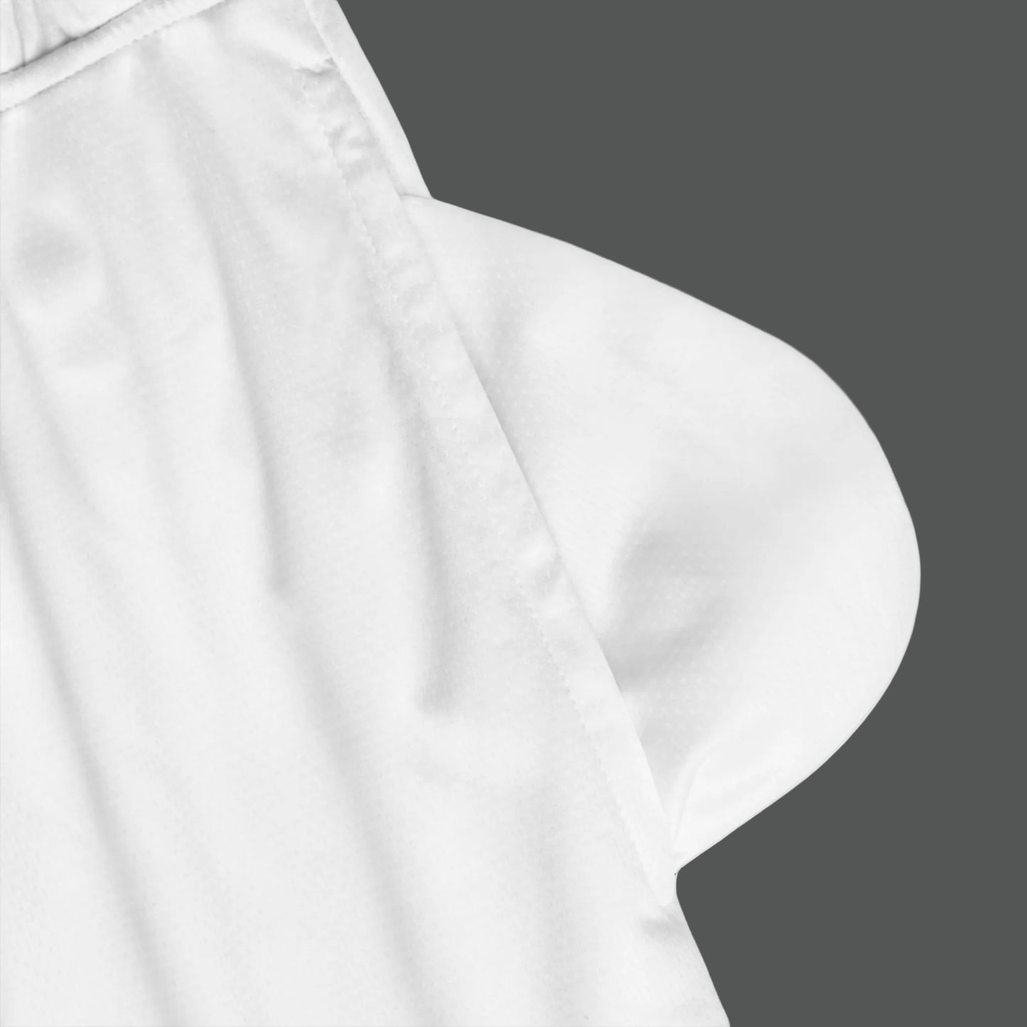 Close-up of a white satin pillow with a soft texture on a white background