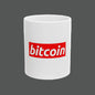 White mug with red 'bitcoin' logo on a white background