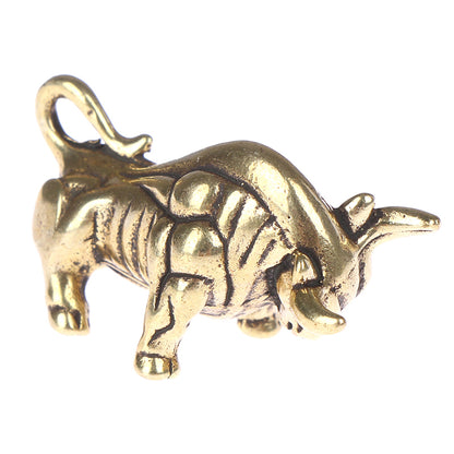 Gold bull charm on a white background