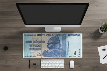 Zimbabwean dollar bill design on a computer monitor, keyboard, and mouse.