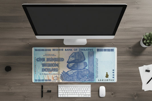 Zimbabwean dollar bill design on a computer monitor, keyboard, and mouse.