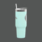 Mint green tumbler with a straw on a white background