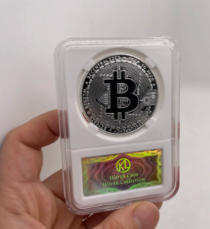 Silver Bitcoin coin in a protective case held by a hand on a white background
