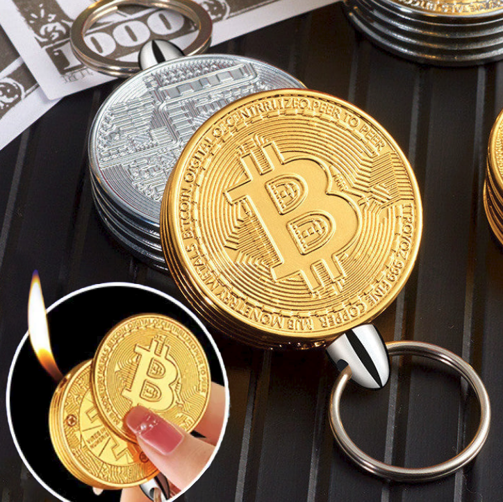 Gold and silver Bitcoin coin lighters with a lighter, keychain, and money on a black surface.