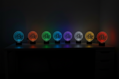 Seven Bitcoin symbol lights in different colors on a dark background