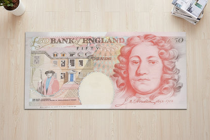 Fifty-pound Bank of England note on a wooden surface
